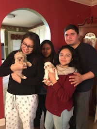 a group of people posing for a picture in a kitchen