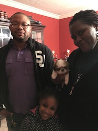 a family posing for a picture in a living room